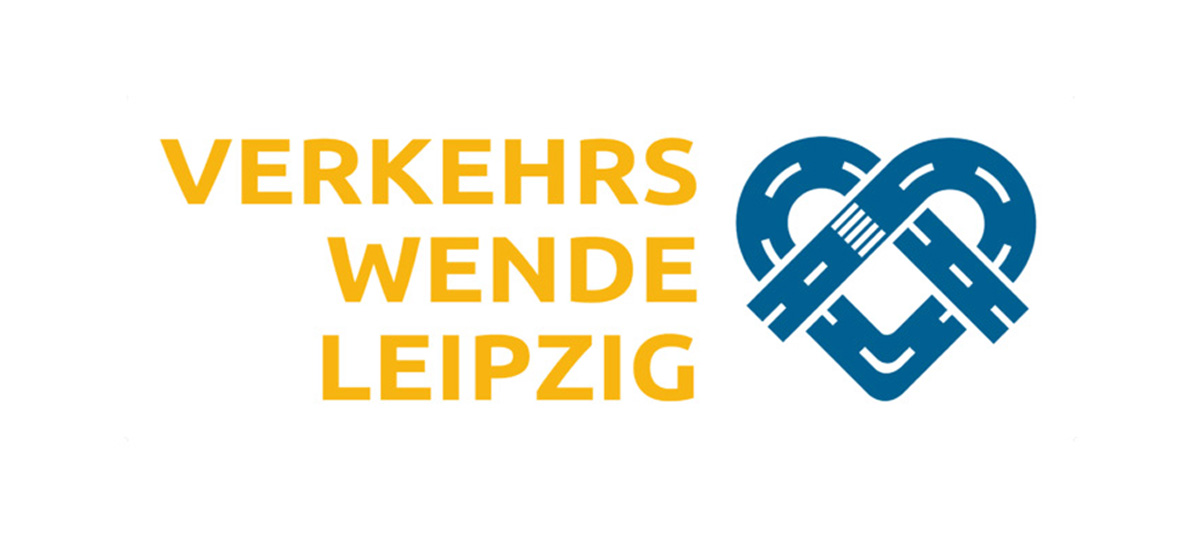 Logo der Verkehrswende Leipzig: links der Text und rechts ein Brezelherz aus einer angedeuteten Straße mit einem kleinen Zebrastreifen. 